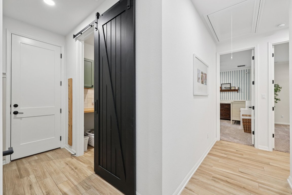 2913 Fallcrest Bend Leander, TX 78641 - Photo 20 of 40 a view of a hallway with wooden floor and a bathroom