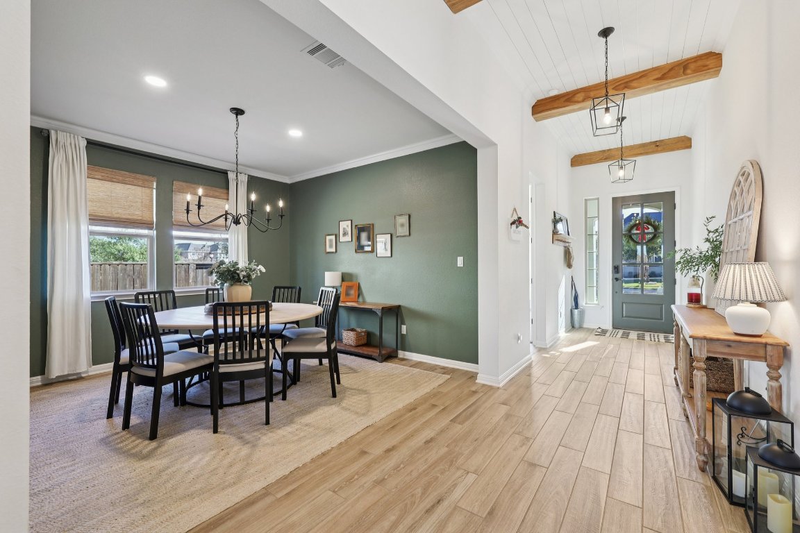 2913 Fallcrest Bend Leander, TX 78641 - Photo 2 of 40 a view of a dining room with furniture and wooden floor
