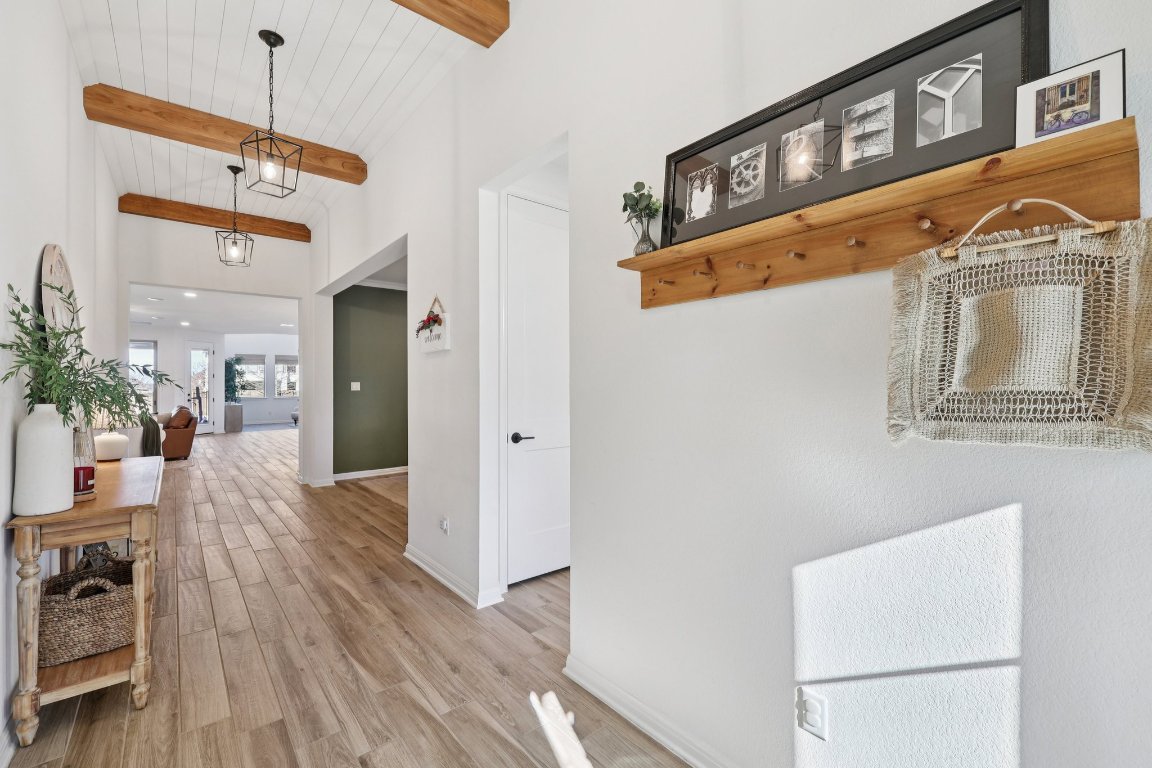 2913 Fallcrest Bend Leander, TX 78641 - Photo 7 of 40 a view of a hallway with a dining table and chairs