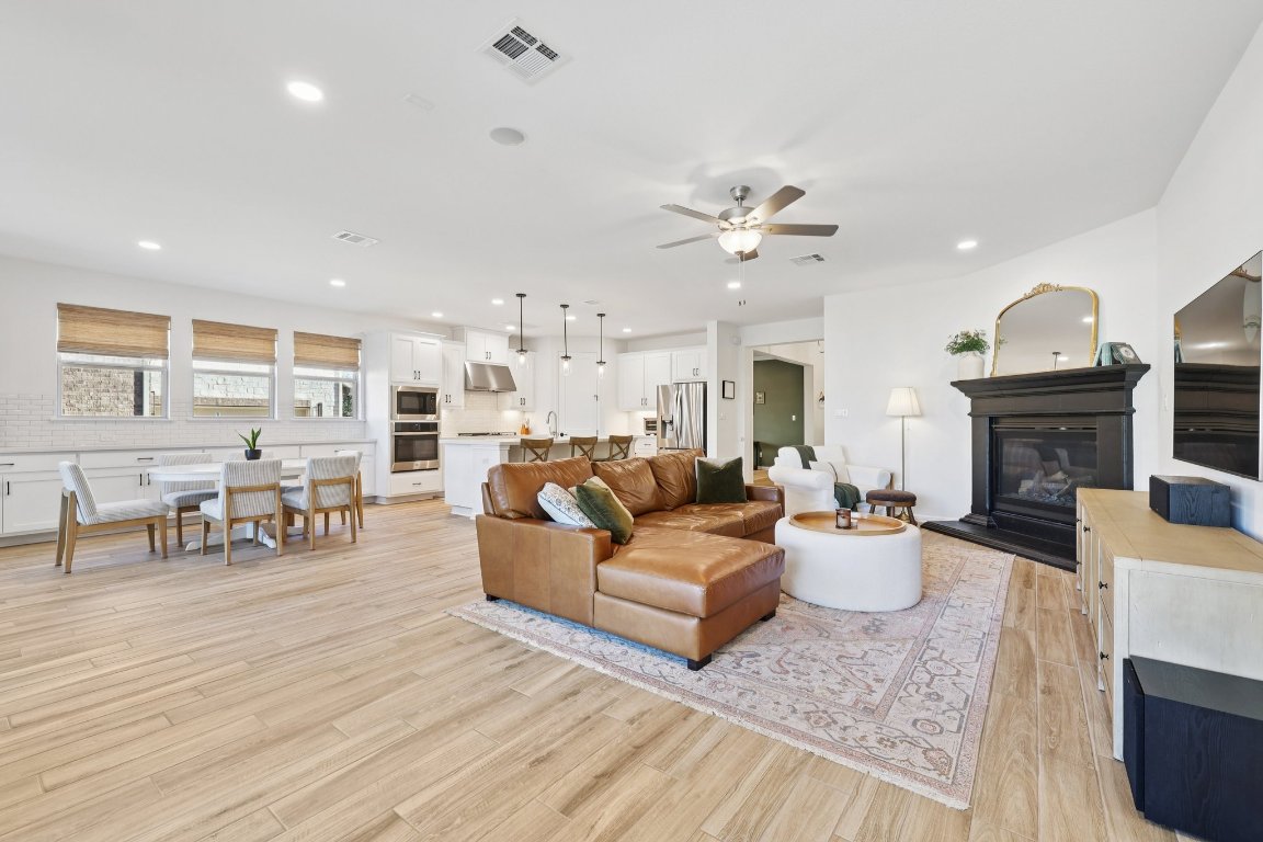 2913 Fallcrest Bend Leander, TX 78641 - Photo 9 of 40 a living room with fireplace furniture and a wooden floor