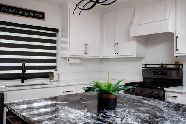 a kitchen with a stove a microwave and cabinets
