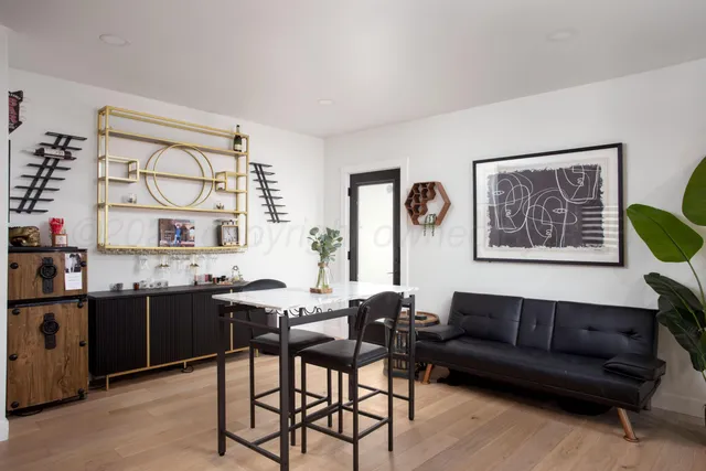 a living room with furniture a rug and a window