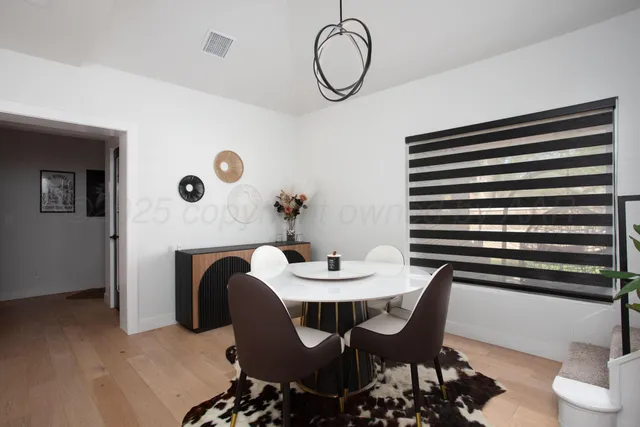 a view of a dining room with furniture and wooden floor