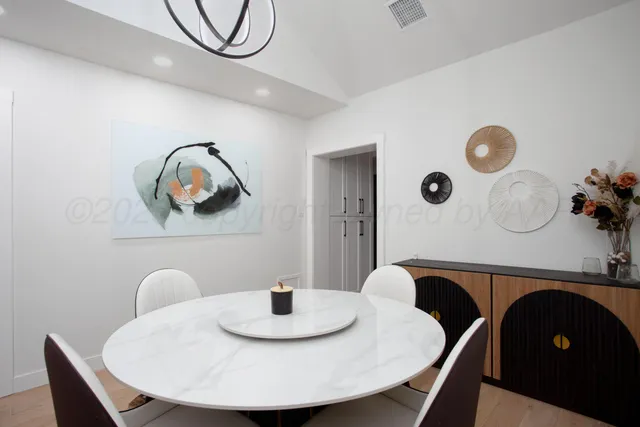 a kitchen with a table and chairs