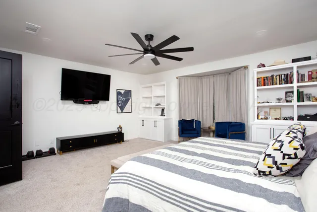 a bedroom with a bed and a flat screen tv