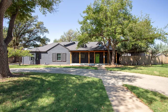 a front view of house with yard and green space