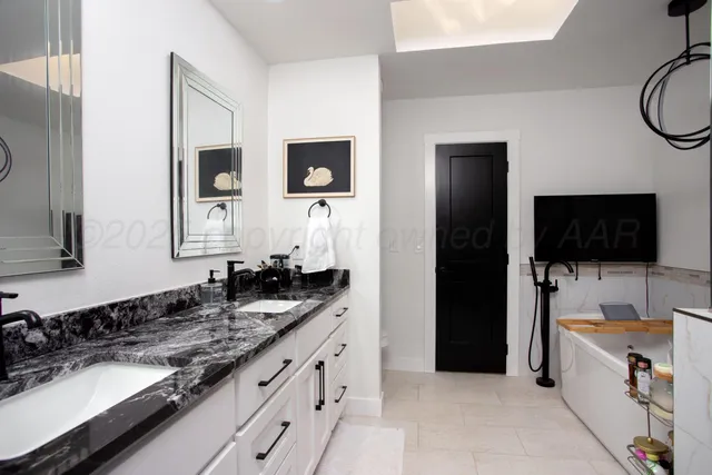 a en suite bathroom with a sink and a mirror