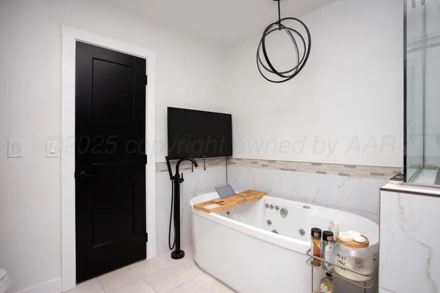 a bathroom with a tub sink and a mirror