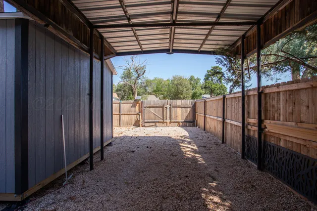 a view of a backyard with wooden fence