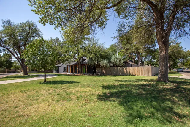 a house is sitting in middle of forest
