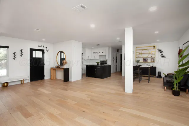 a view of kitchen with furniture and a refrigerator