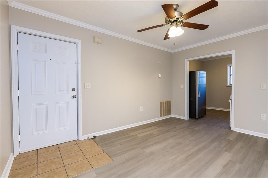 953 Washington Street Southwest, Unit 2 Atlanta, GA 30315 - Photo 2 of 14 a view of an empty room with window and a ceiling fan