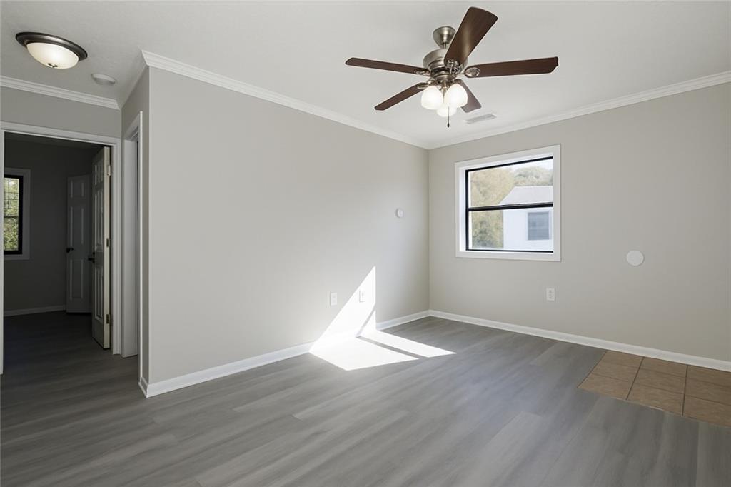 953 Washington Street Southwest, Unit 2 Atlanta, GA 30315 - Photo 7 of 14 a view of an empty room with wooden floor and a window