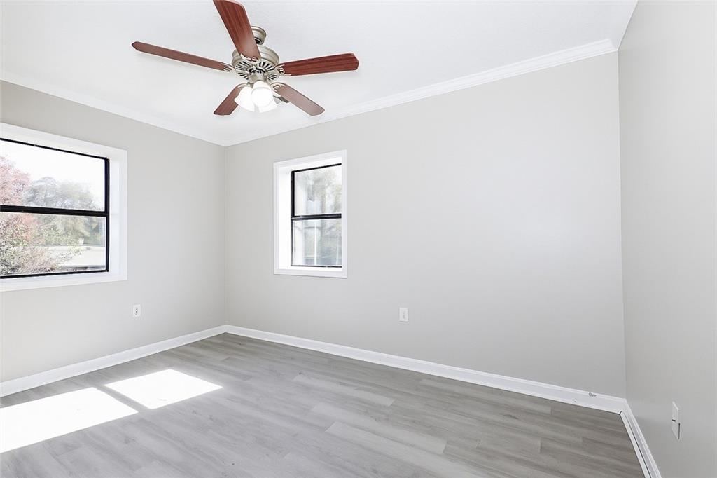 953 Washington Street Southwest, Unit 2 Atlanta, GA 30315 - Photo 10 of 14 an empty room with wooden floor and windows