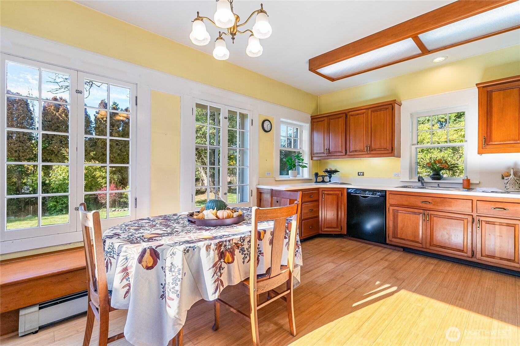 3905 Idaho Street Bellingham, WA 98229 - Photo 19 of 40 a kitchen with stainless steel appliances granite countertop a stove a refrigerator a sink a dining table and chairs with wooden floor