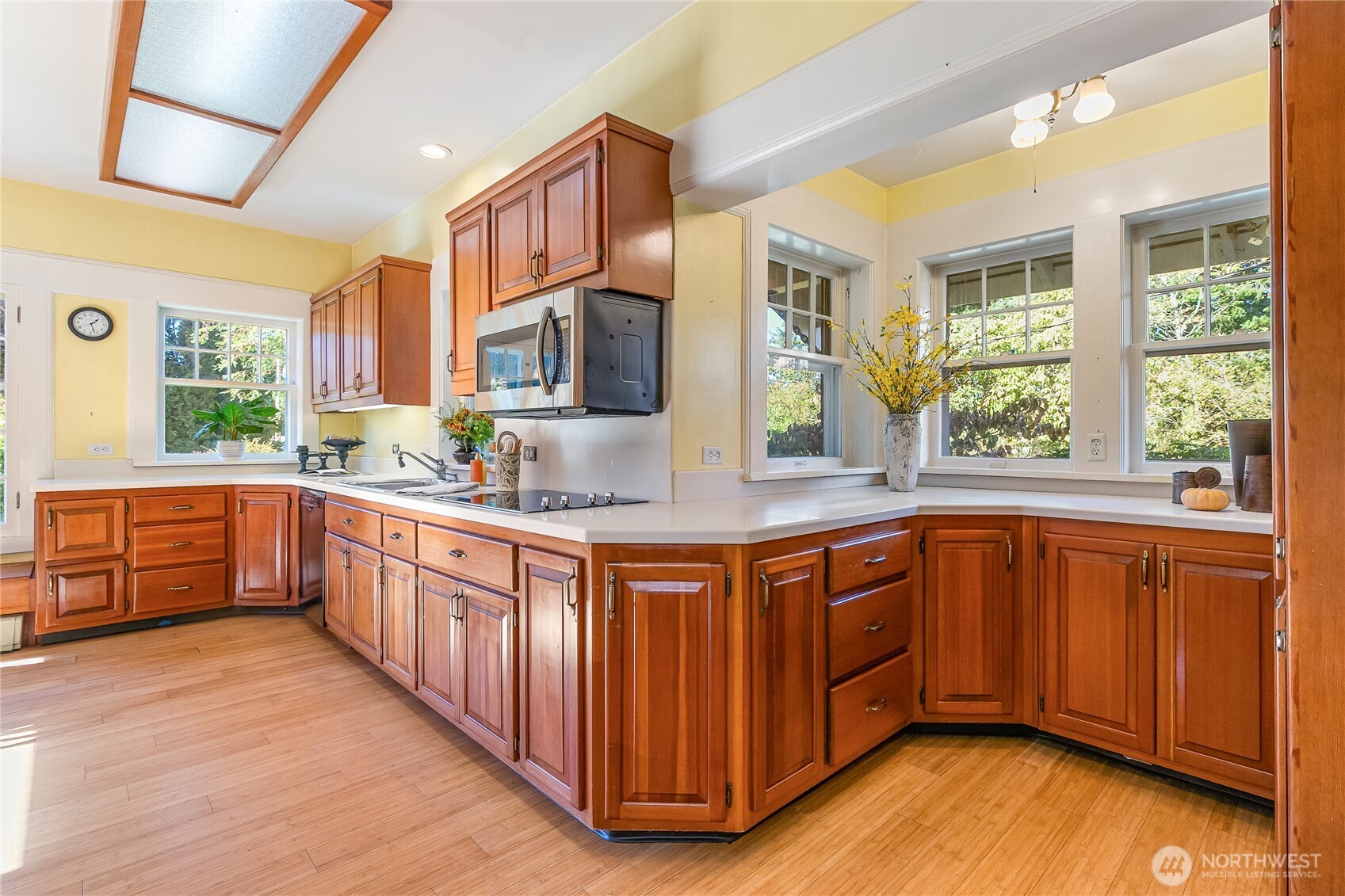3905 Idaho Street Bellingham, WA 98229 - Photo 21 of 40 a kitchen with stainless steel appliances granite countertop wooden cabinets a sink a stove a dining table and chairs