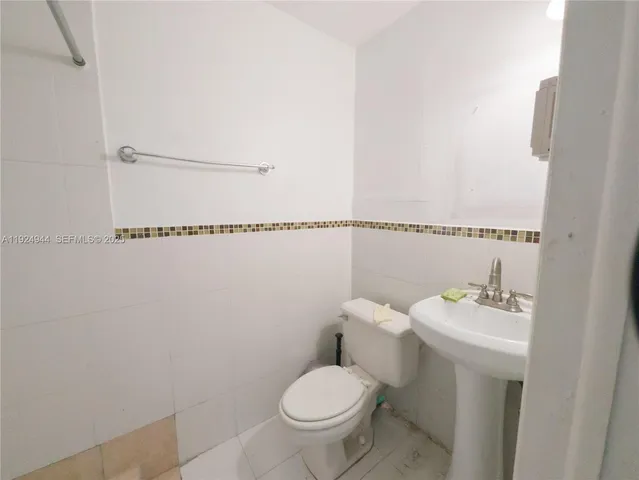 a white toilet sitting next to a bathroom sink