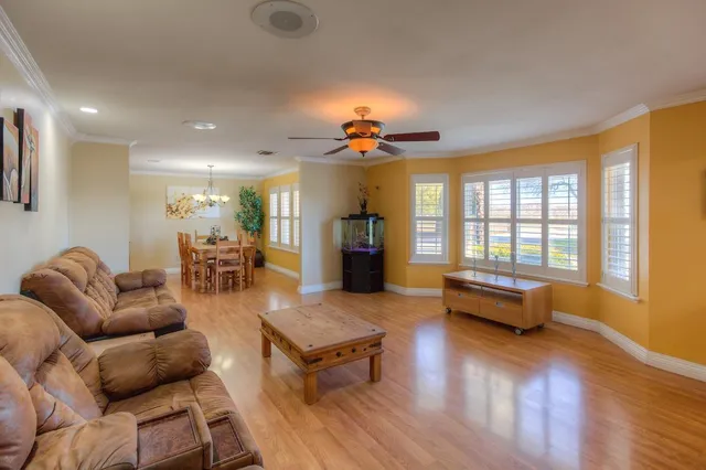 a living room with furniture and wooden floor