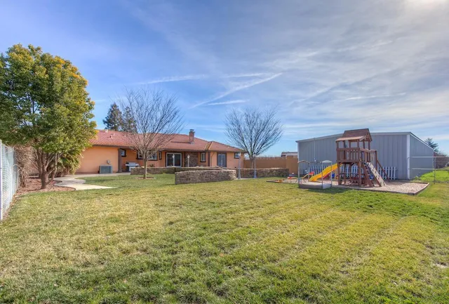 a view of a house with a yard and sitting area