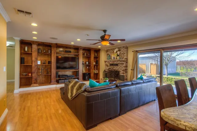 a living room with furniture and a floor to ceiling window
