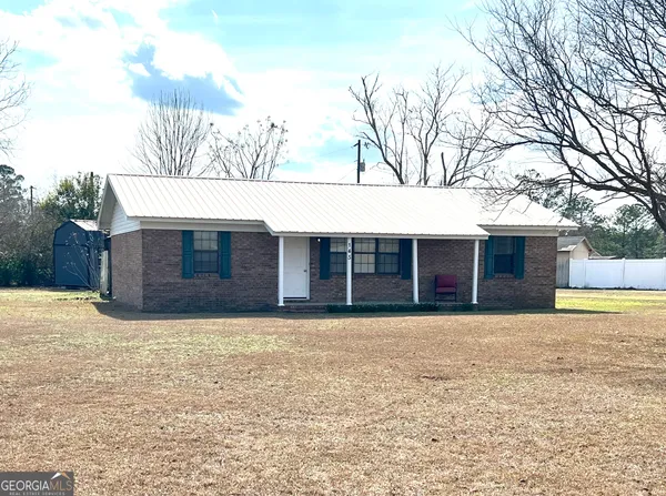 a kitchen with a sink cabinets and wooden floor