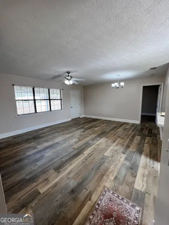 a view of an empty room with a chandelier