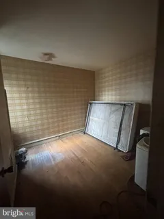 a bathroom with a toilet a sink a window and mirror