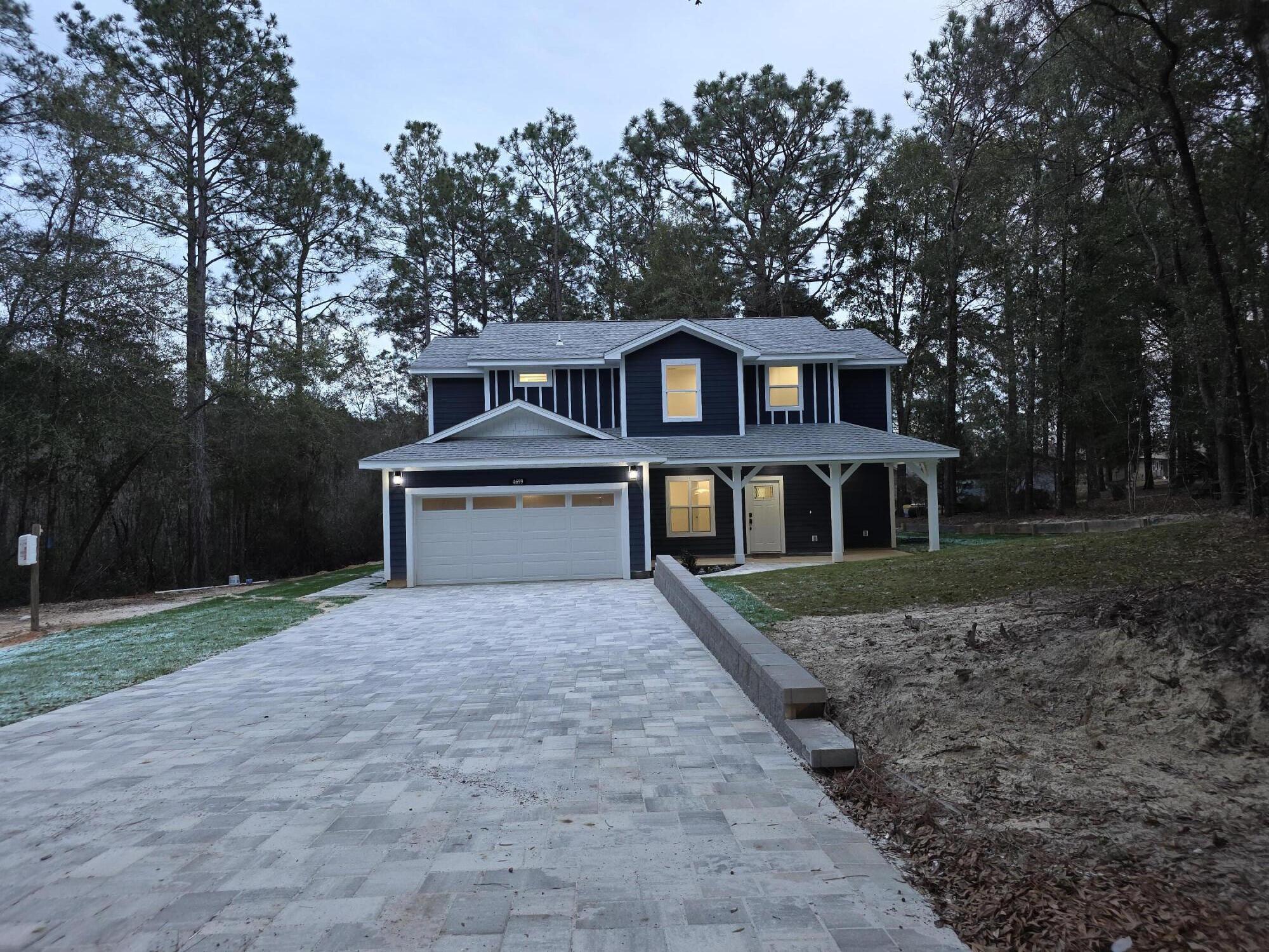 a house that has a tree in front of a house