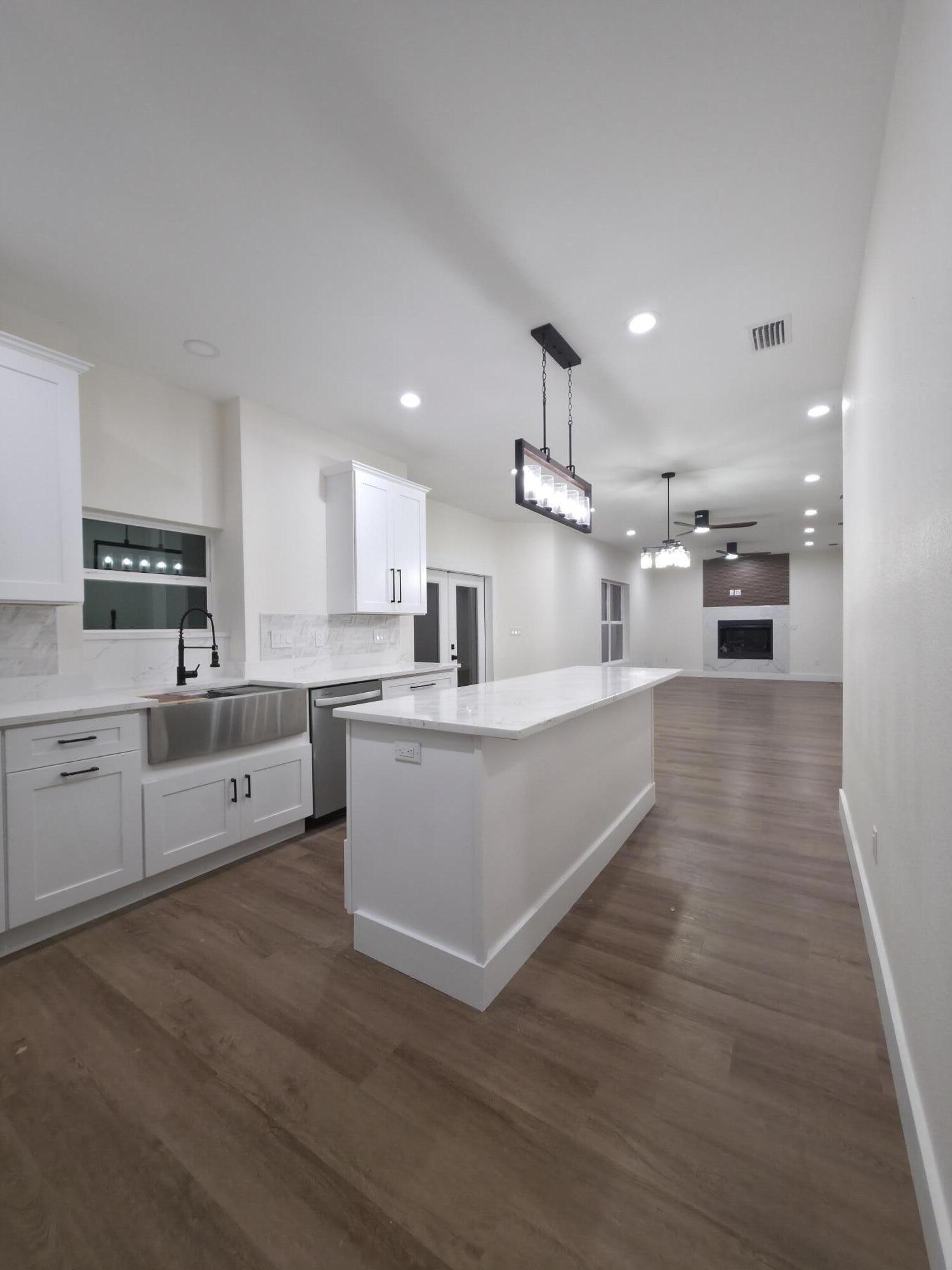 4699 Meadow Lake Drive Crestview, FL 32539 - Photo 12 of 38 a large kitchen with stainless steel appliances kitchen island a large counter top and a stove top oven