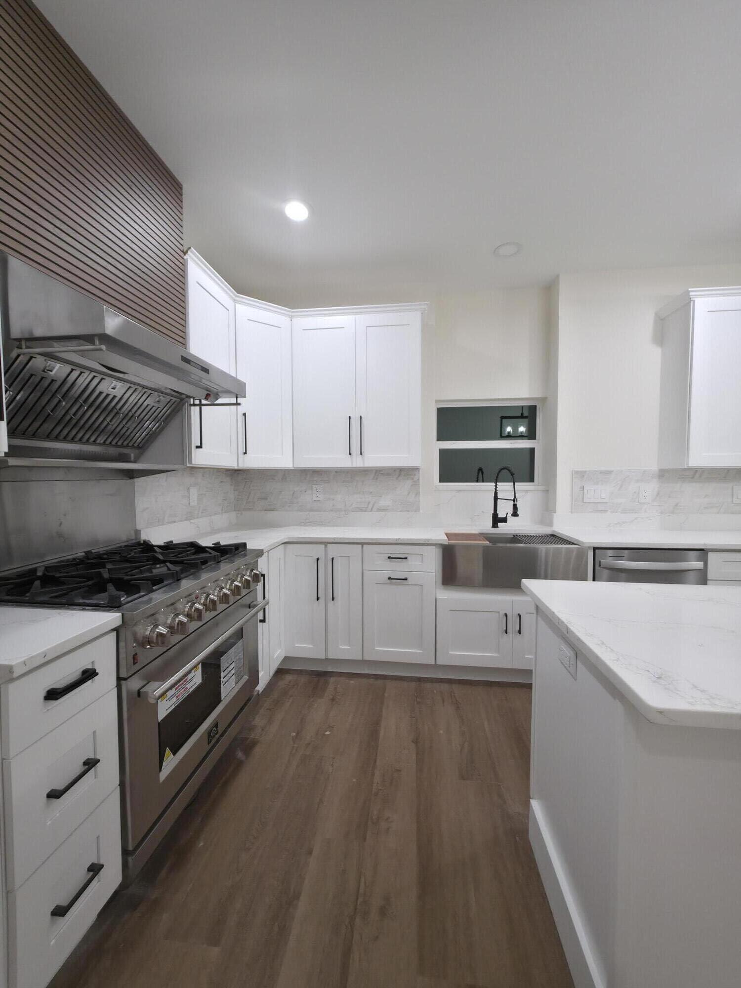 4699 Meadow Lake Drive Crestview, FL 32539 - Photo 13 of 38 a kitchen with a sink stove top oven and cabinets