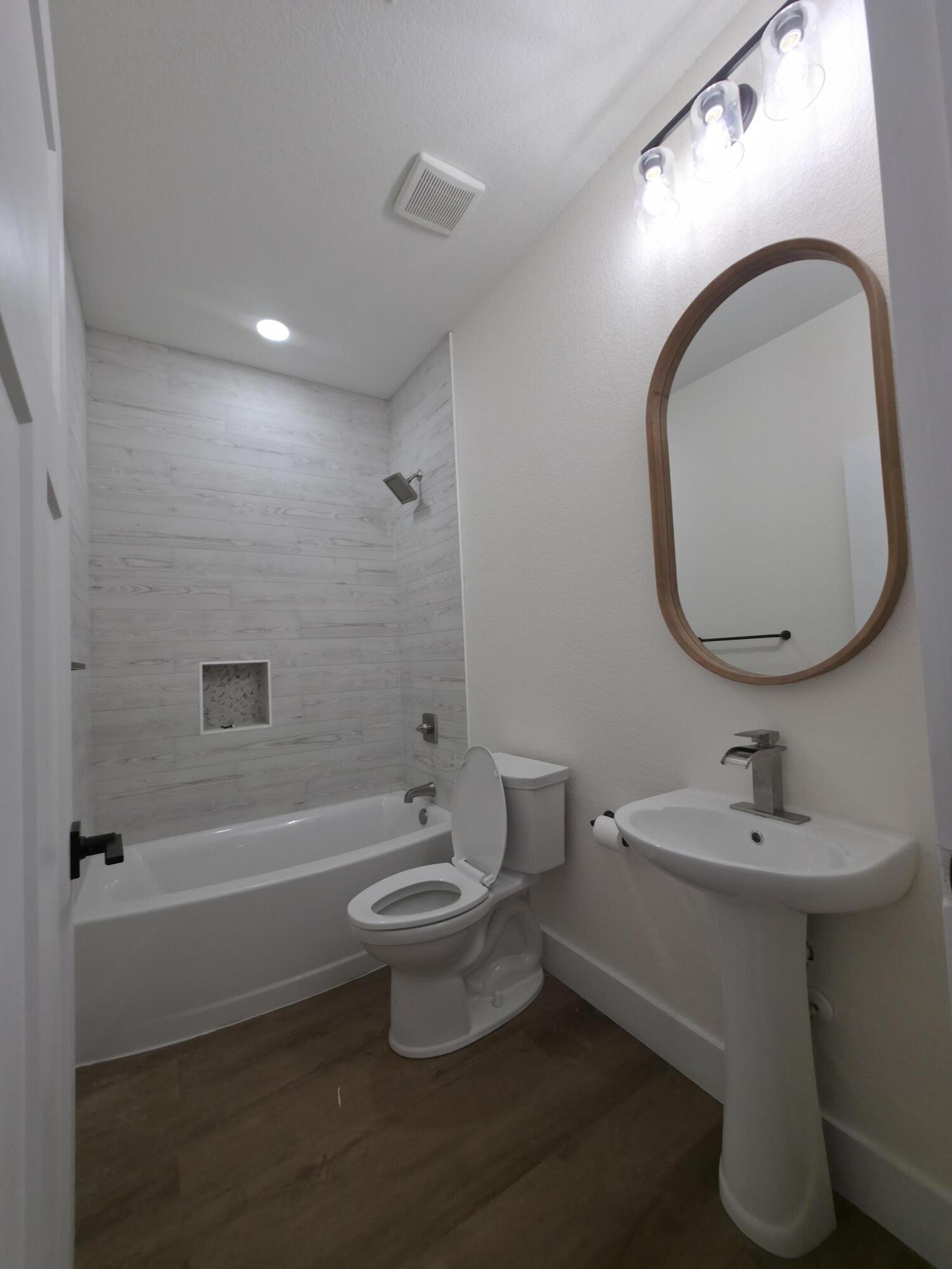 4699 Meadow Lake Drive Crestview, FL 32539 - Photo 16 of 38 a bathroom with a sink toilet and a mirror