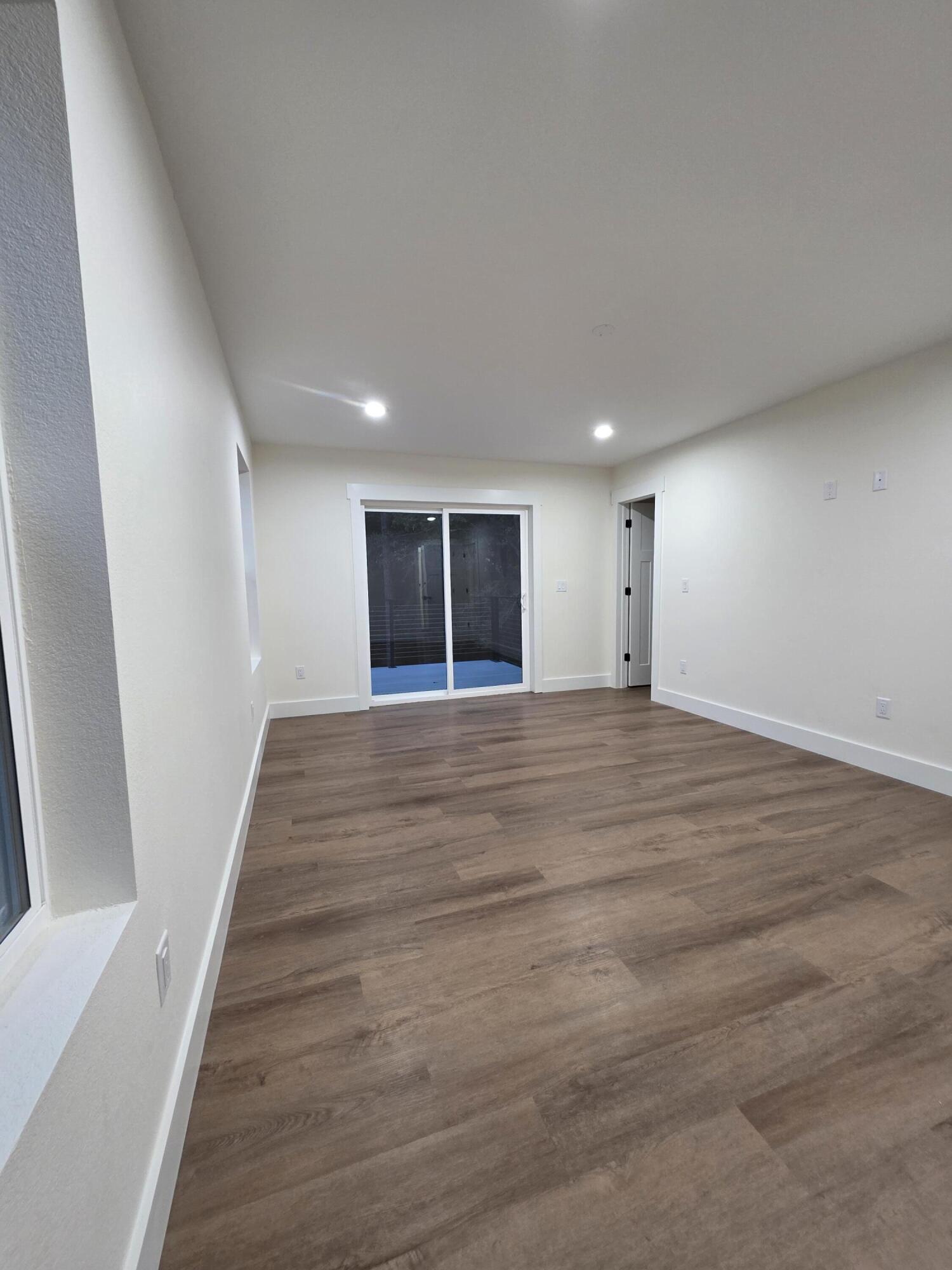 4699 Meadow Lake Drive Crestview, FL 32539 - Photo 27 of 38 a view of an empty room with wooden floor and stairs