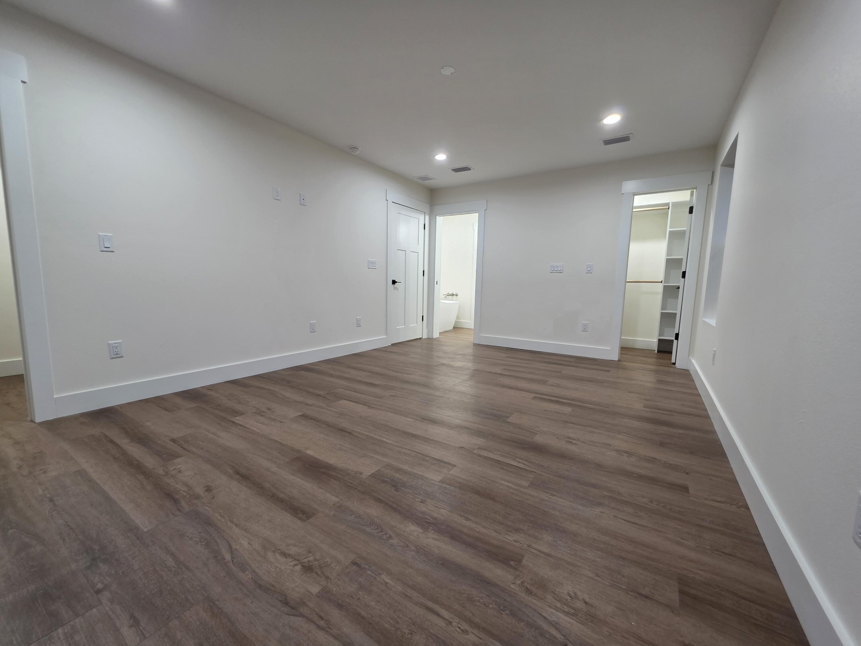 4699 Meadow Lake Drive Crestview, FL 32539 - Photo 28 of 38 a view of an empty room with wooden floor and a window