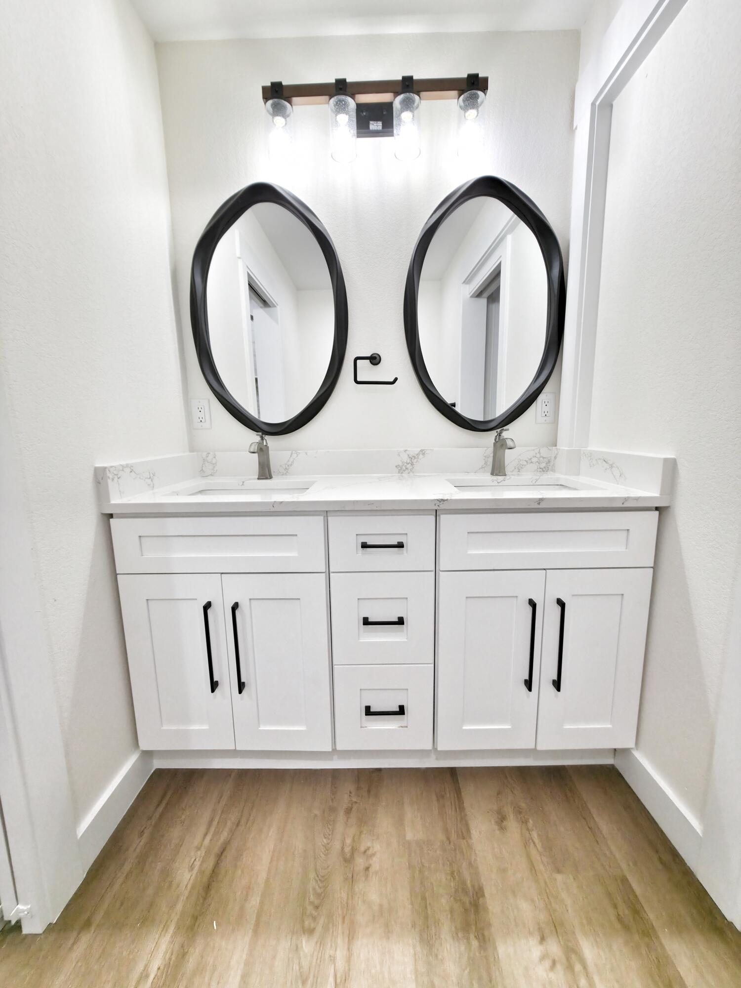 4699 Meadow Lake Drive Crestview, FL 32539 - Photo 29 of 38 a bathroom with a granite countertop toilet a sink and a mirror