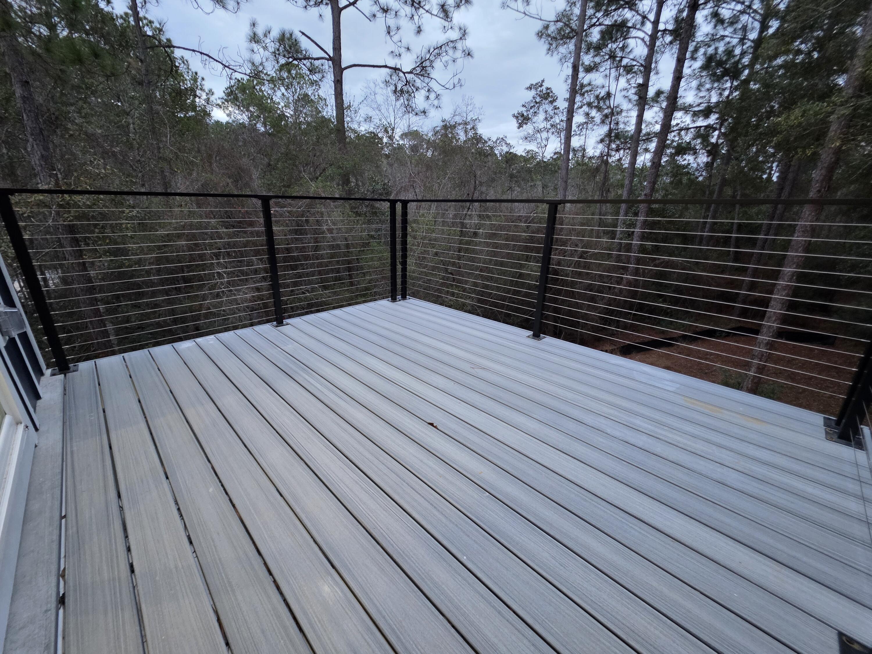 4699 Meadow Lake Drive Crestview, FL 32539 - Photo 34 of 38 a terrace with wooden floor and fence