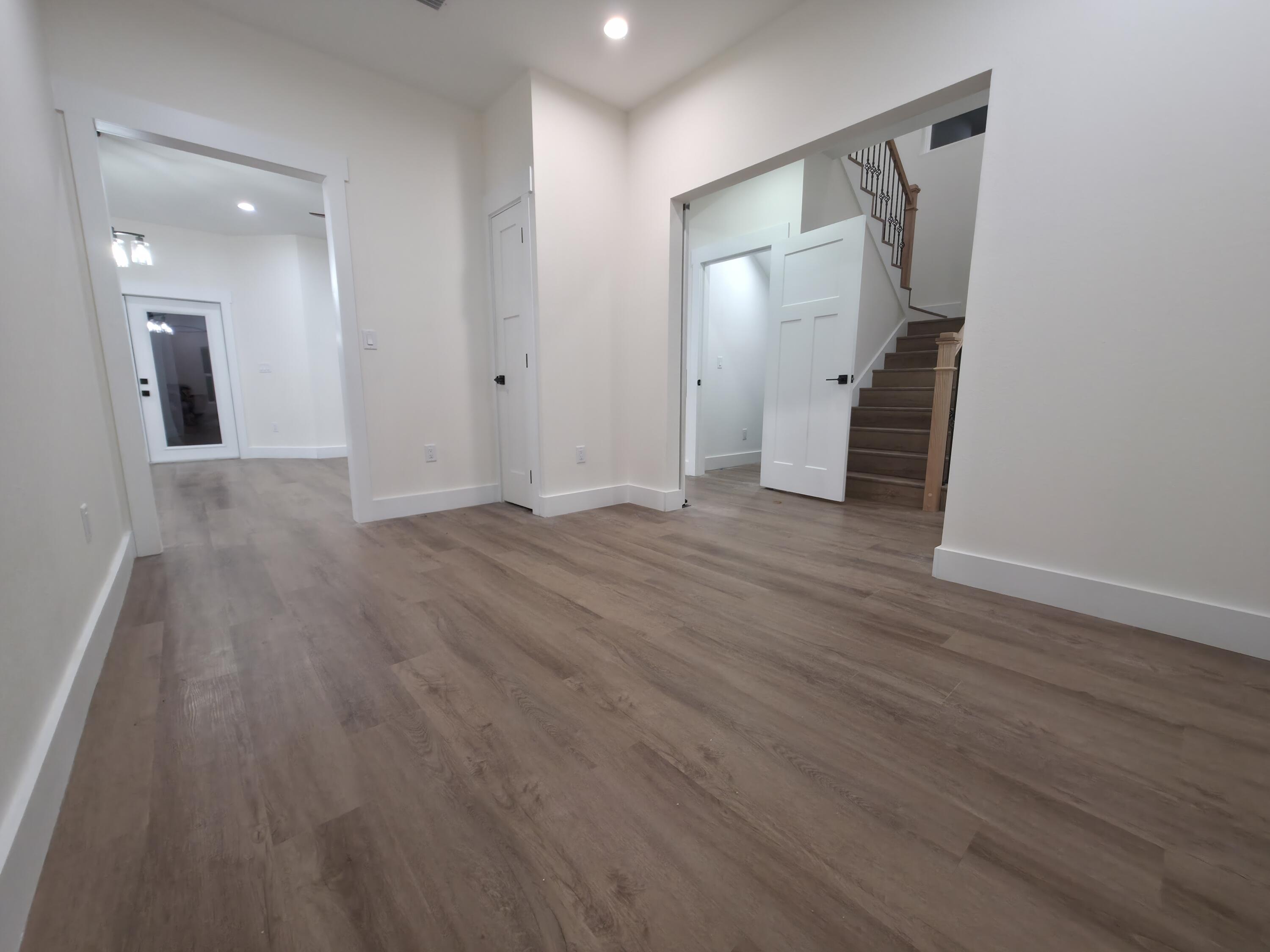 4699 Meadow Lake Drive Crestview, FL 32539 - Photo 8 of 38 wooden floor in an empty room with a mirror
