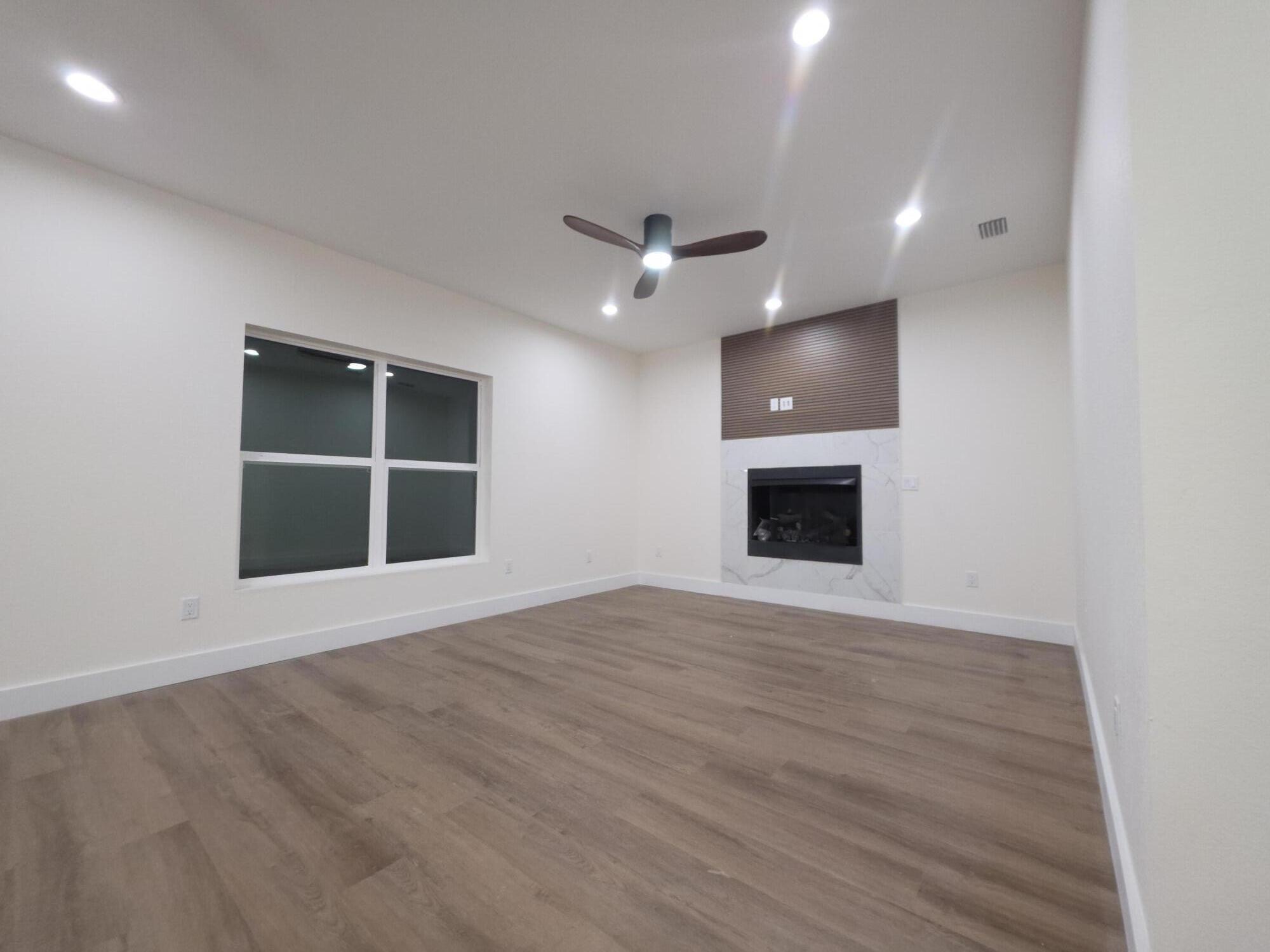 4699 Meadow Lake Drive Crestview, FL 32539 - Photo 9 of 38 a view of an empty room with a window and a kitchen