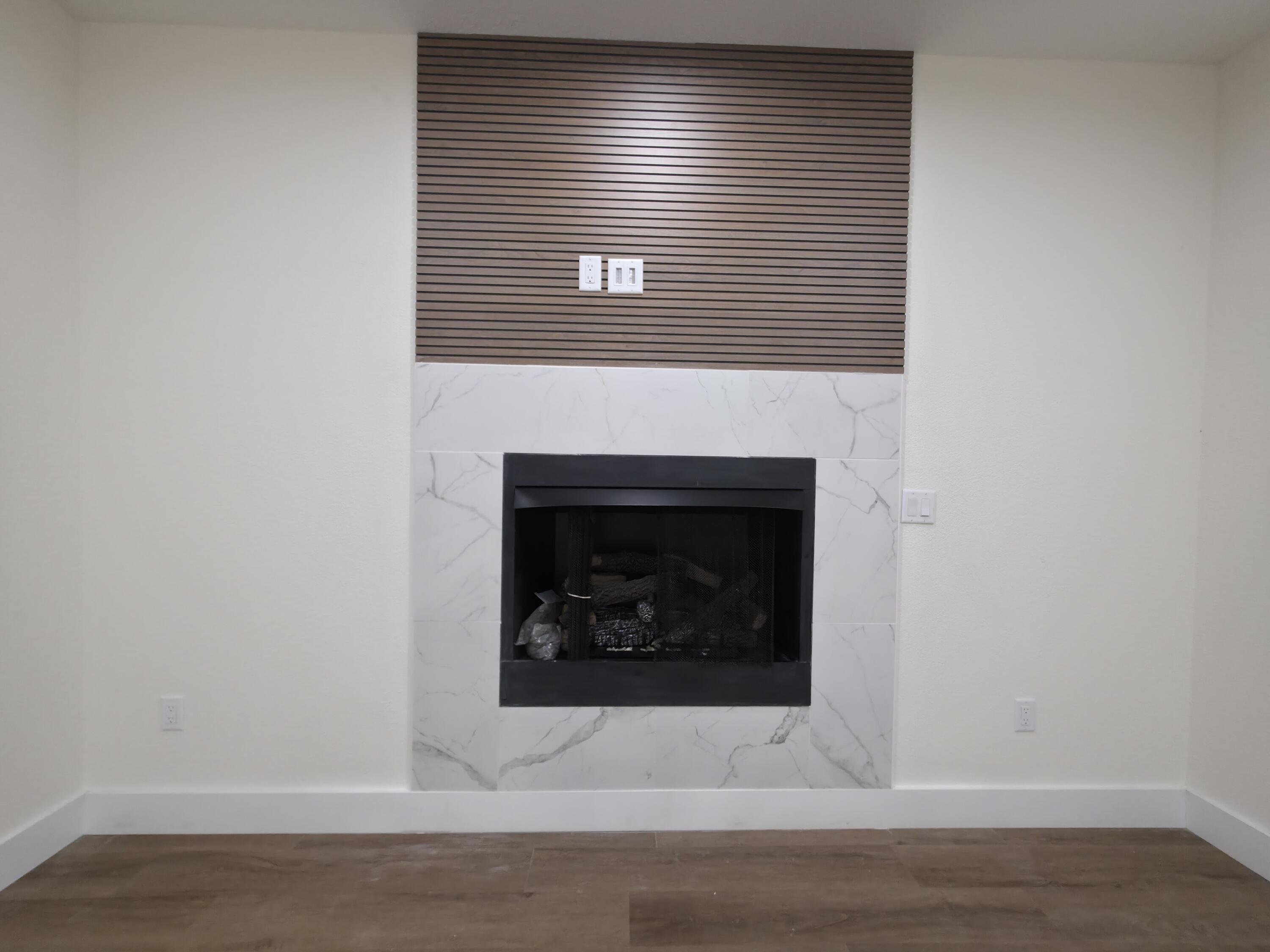4699 Meadow Lake Drive Crestview, FL 32539 - Photo 10 of 38 a view of an empty room with wooden floor and a fireplace