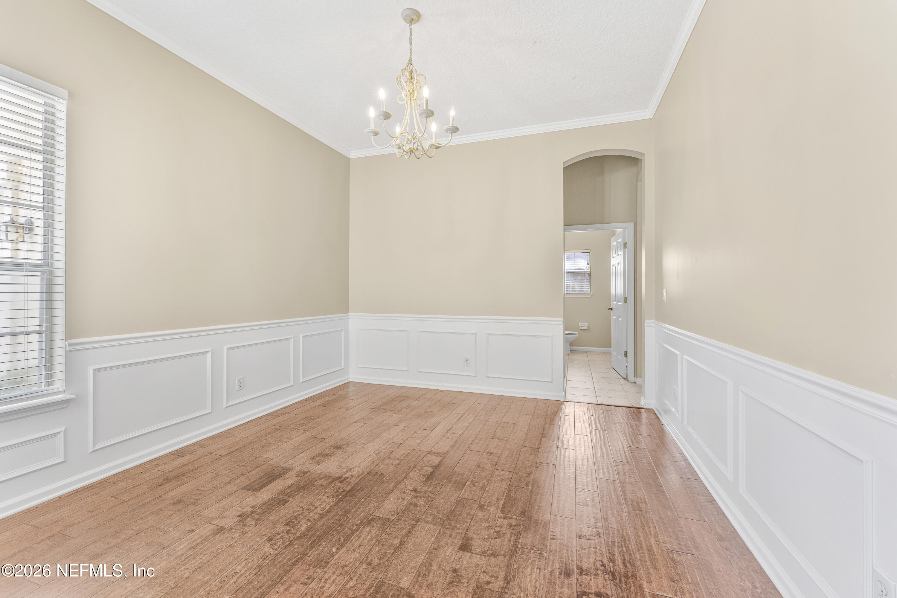 1896 Bluebonnet Way Fleming Island, FL 32003 - Photo 11 of 28 a view of an empty room with wooden floor and a window