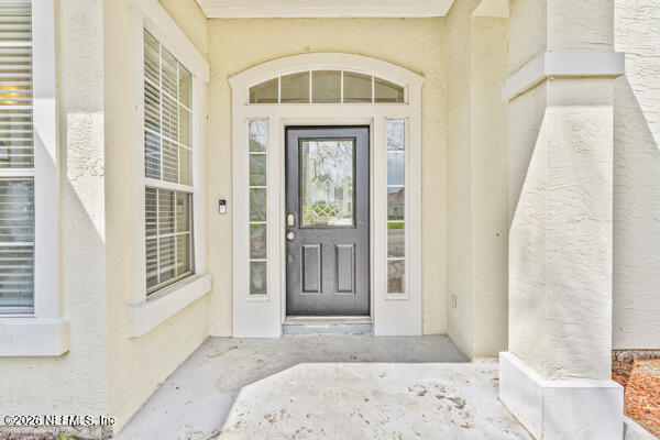 1896 Bluebonnet Way Fleming Island, FL 32003 - Photo 12 of 28 a view of a hallway with wooden floor and a living room