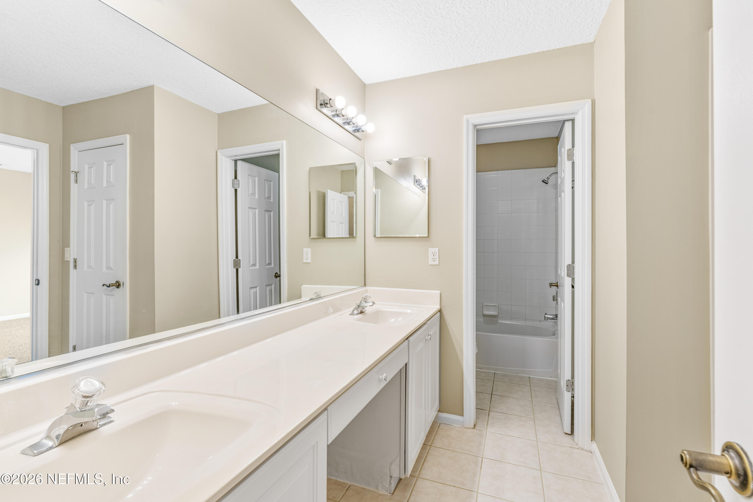 1896 Bluebonnet Way Fleming Island, FL 32003 - Photo 13 of 28 a spacious bathroom with a sink a mirror and a shower