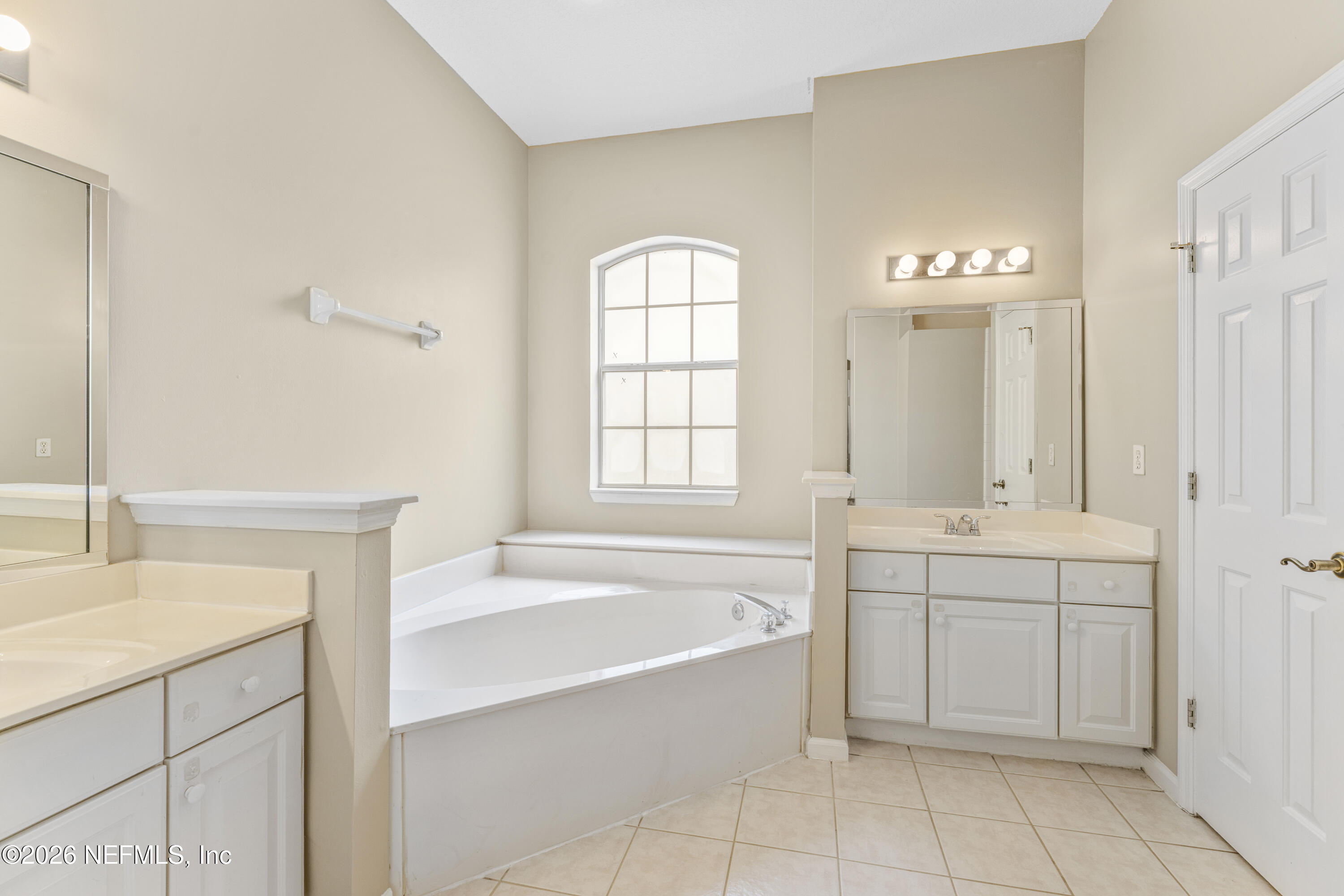 1896 Bluebonnet Way Fleming Island, FL 32003 - Photo 20 of 28 a spacious bathroom with a tub sink and mirror