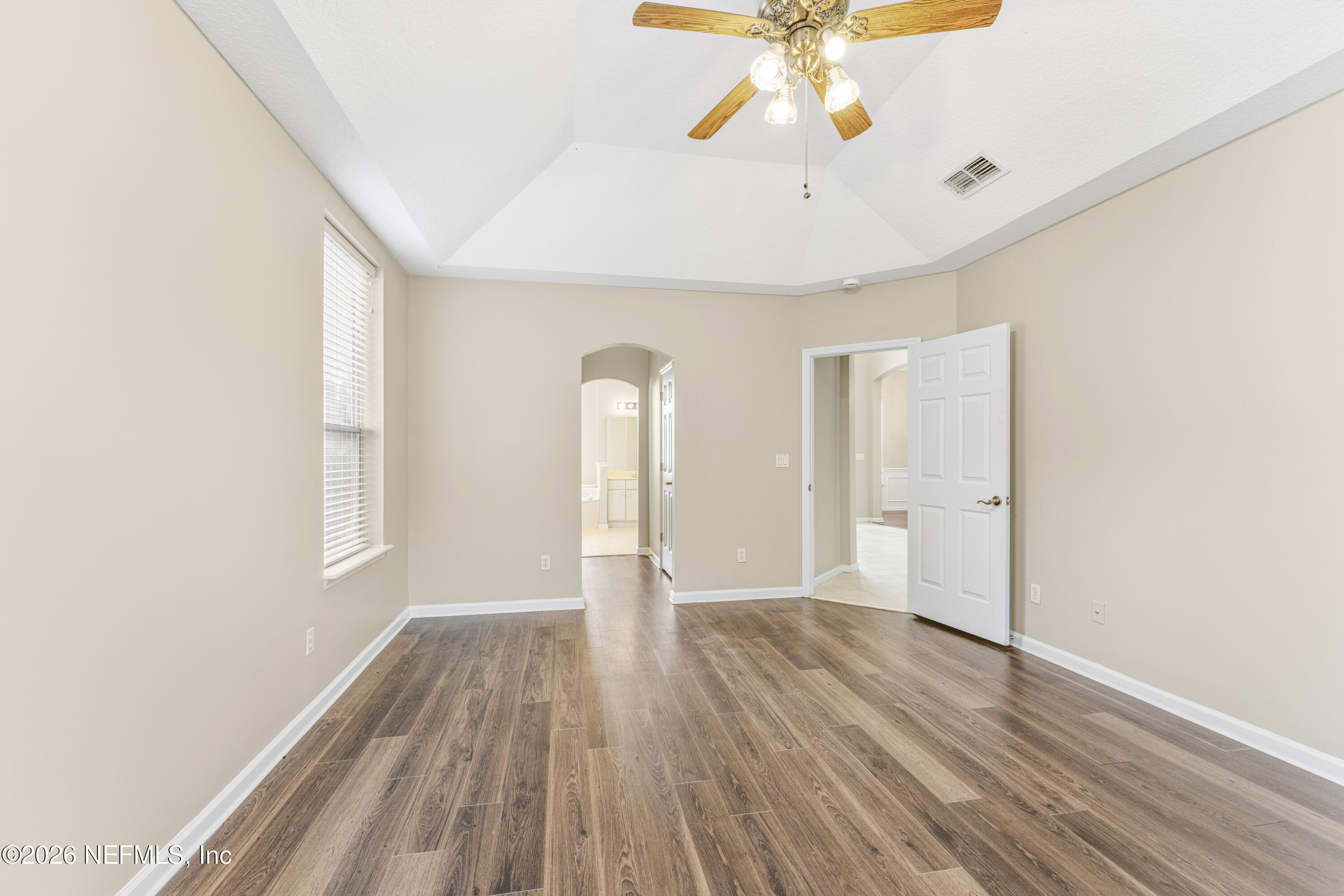 1896 Bluebonnet Way Fleming Island, FL 32003 - Photo 21 of 28 a view of an empty room with window and wooden floor