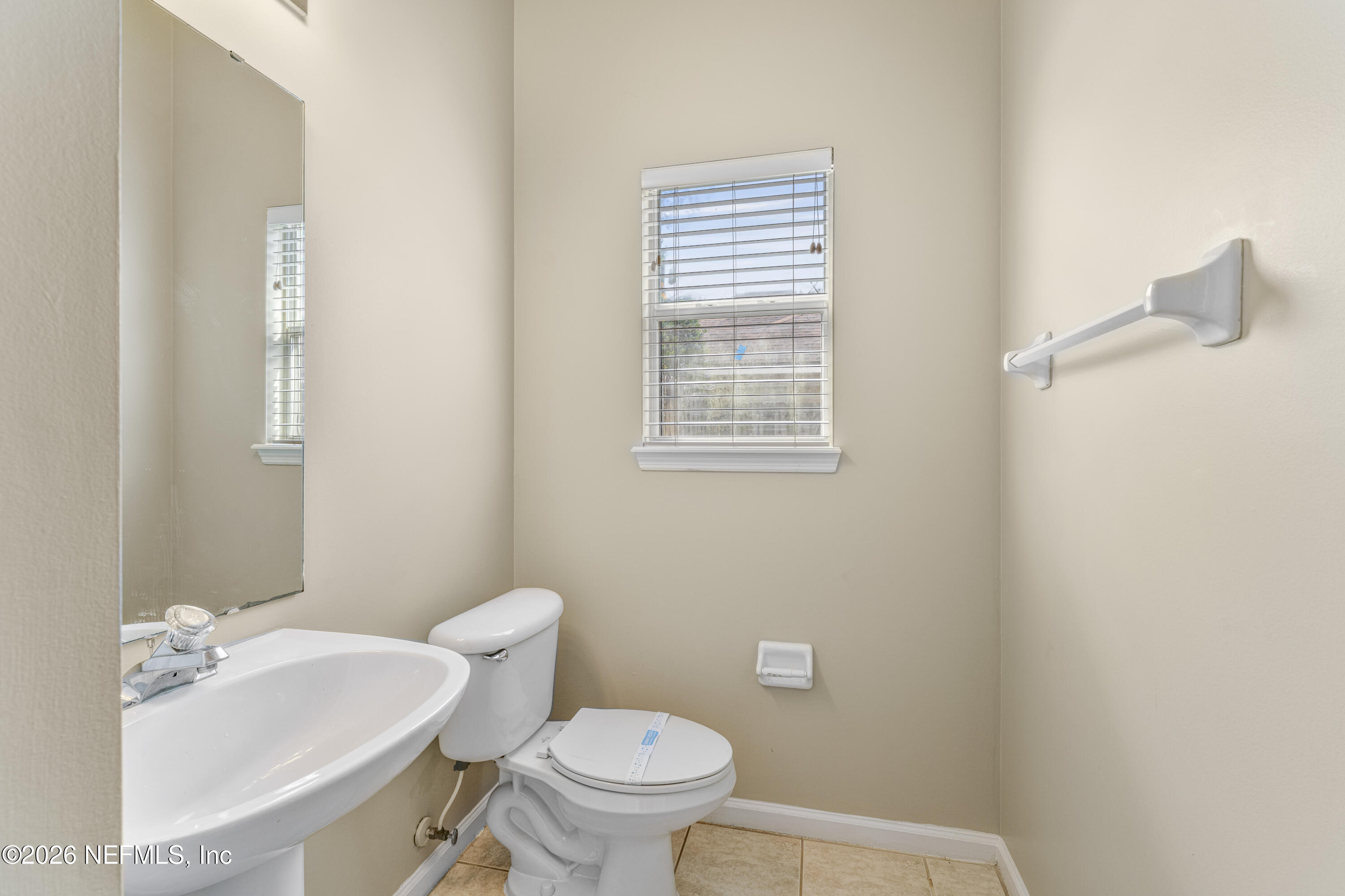 1896 Bluebonnet Way Fleming Island, FL 32003 - Photo 23 of 28 a bathroom with a sink a toilet and a mirror