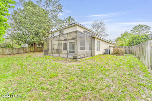 1896 Bluebonnet Way Fleming Island, FL 32003 - Photo 25 of 28 a view of a house with yard and a garden