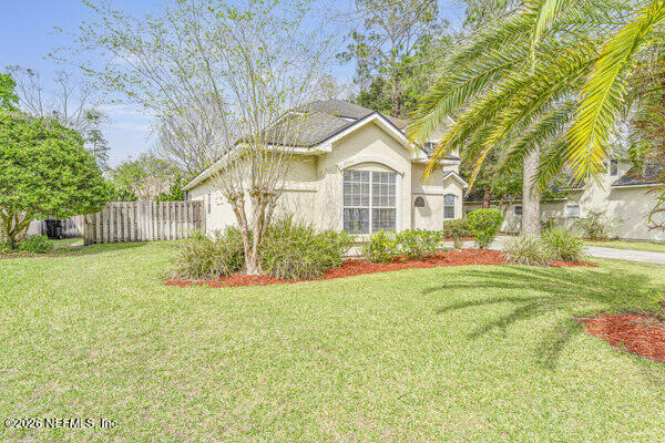 1896 Bluebonnet Way Fleming Island, FL 32003 - Photo 4 of 28 a front view of a house with garden