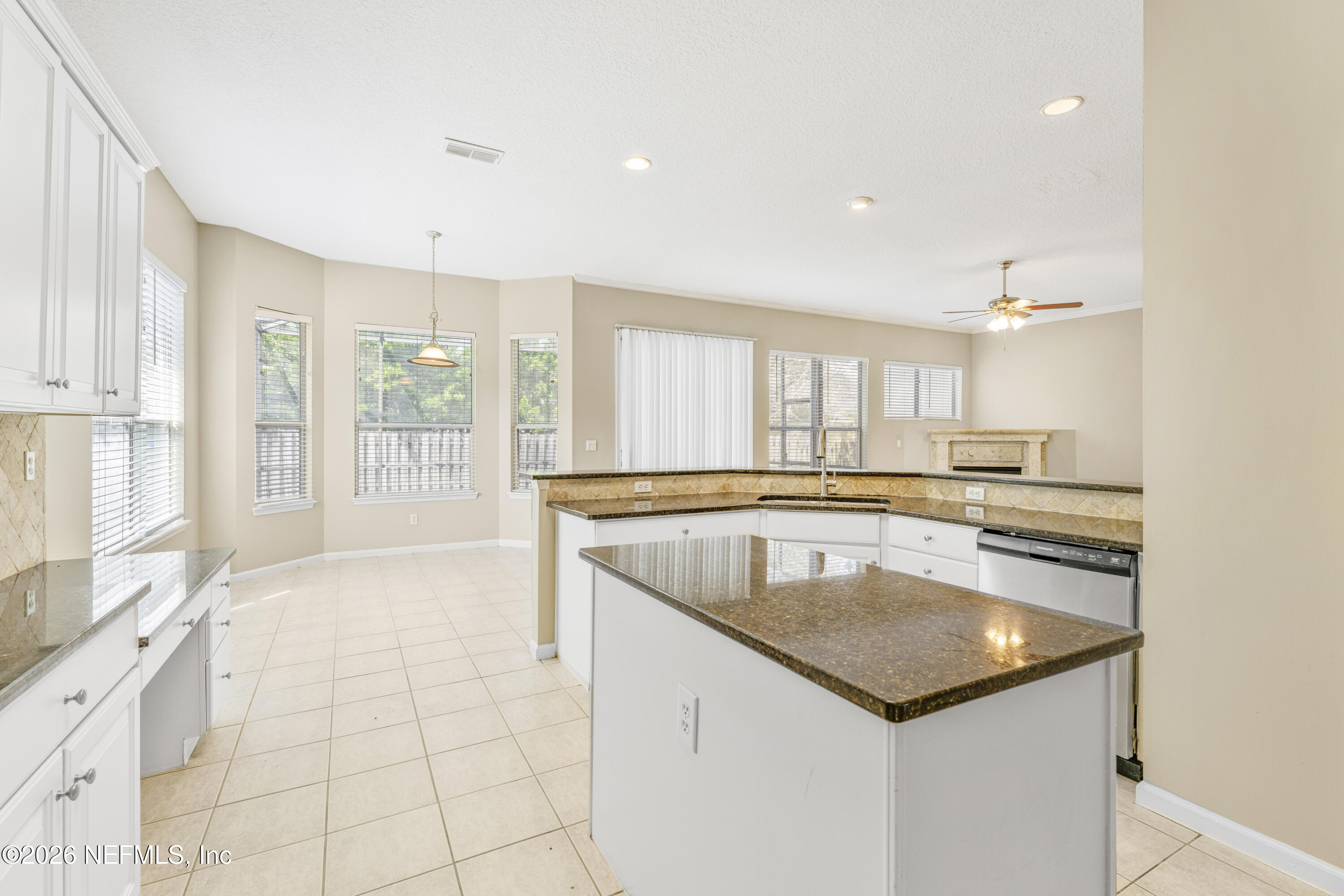1896 Bluebonnet Way Fleming Island, FL 32003 - Photo 6 of 28 a kitchen with a stove a sink and a refrigerator