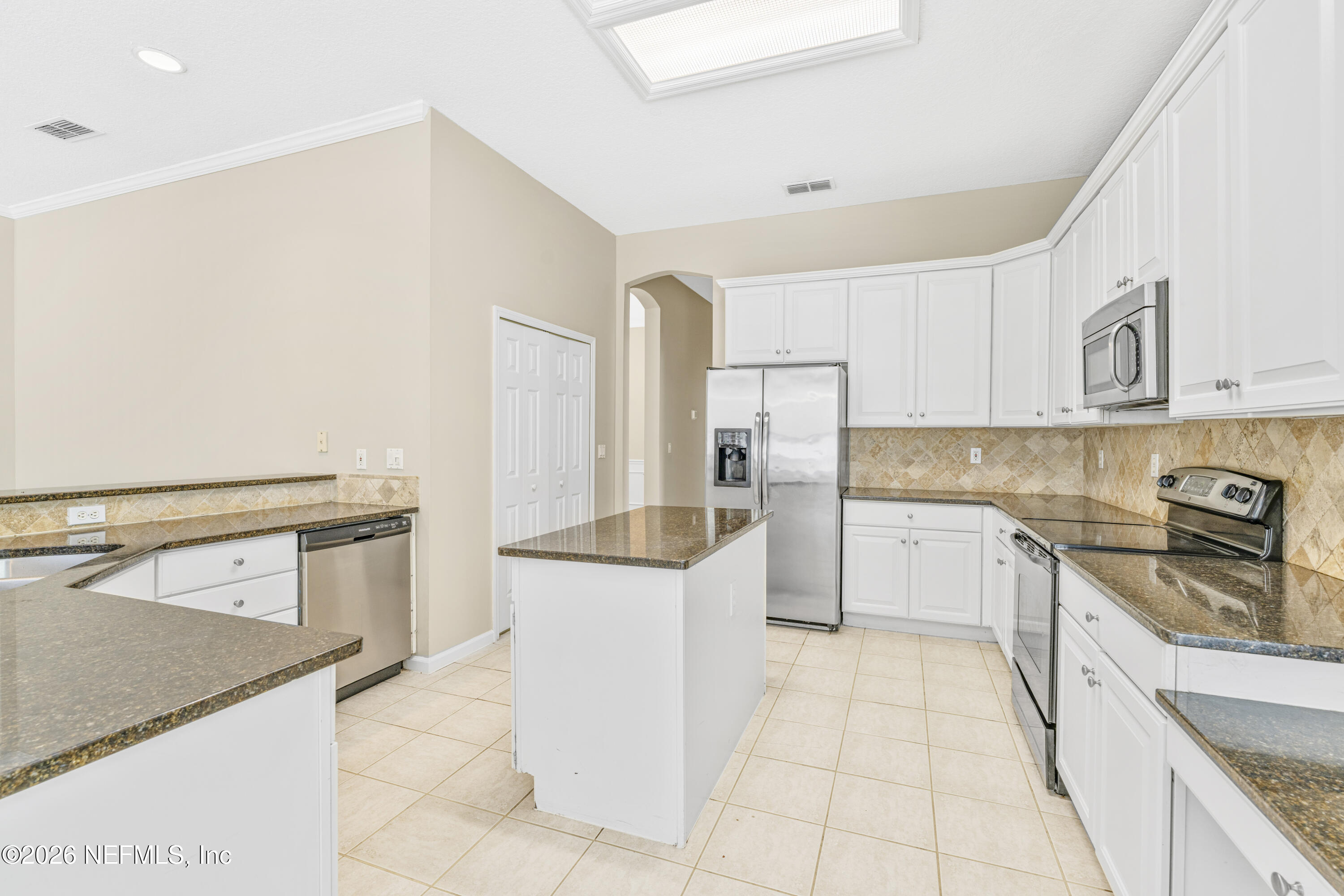 1896 Bluebonnet Way Fleming Island, FL 32003 - Photo 7 of 28 a kitchen with a stove top oven and cabinets