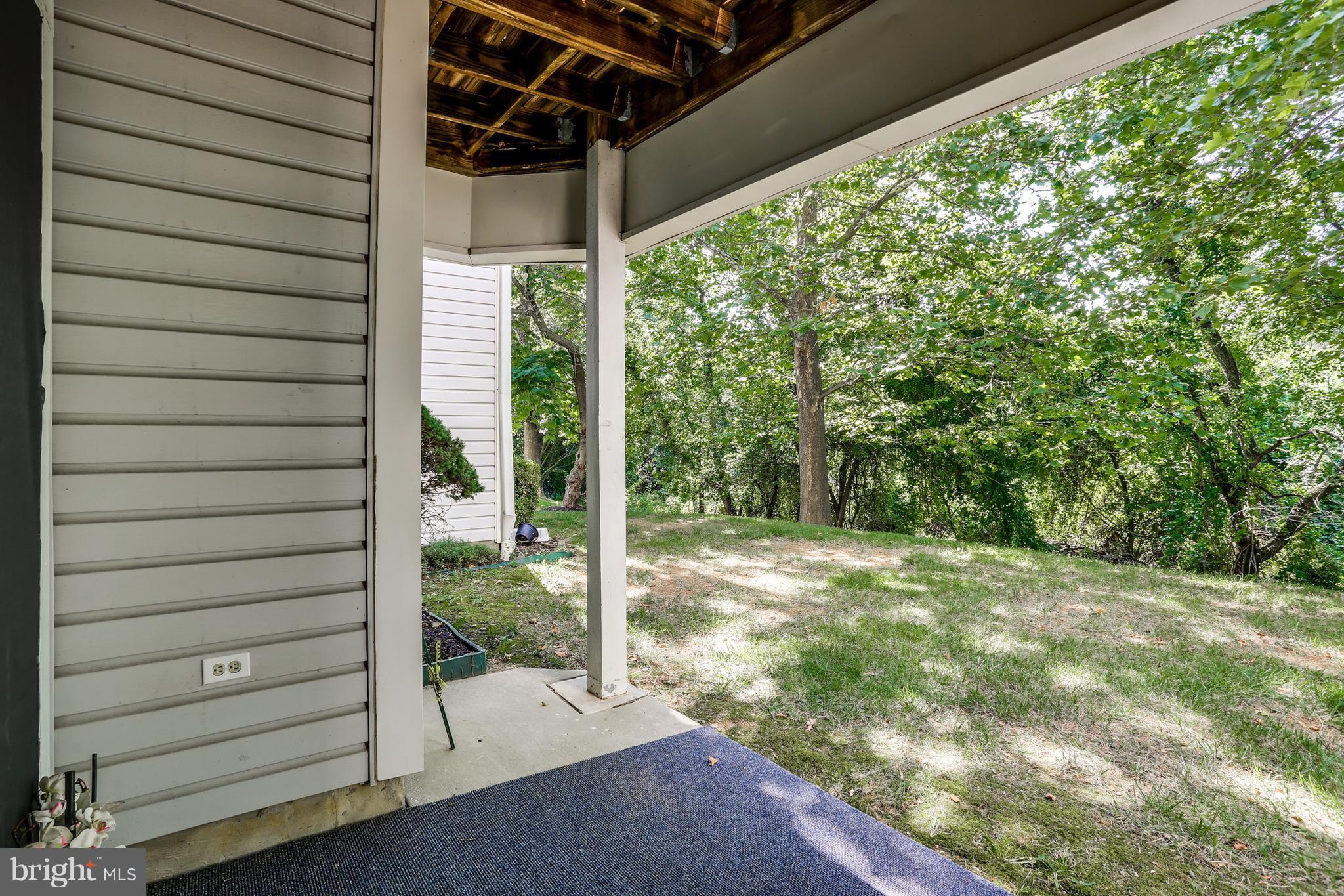 8385 Montgomery Run Road, Unit B Ellicott City, MD 21043 - Photo 26 of 29 Patio with serene setting backs to woods