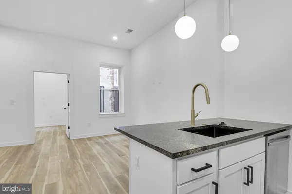 a close view of a sink a faucet and appliance in the kitchen
